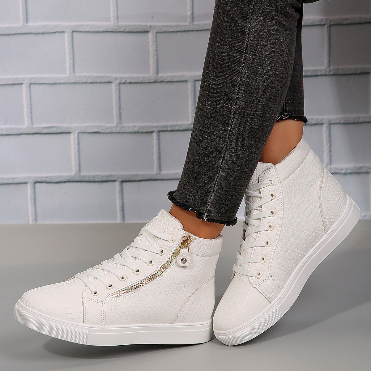 Angled on-foot view of the women’s Brielle Luxe Zip-Wedge High-Top Sneakers in Beige, showing the soft neutral lace-up upper, ankle-high silhouette, textured detailing, side zipper accent, rounded toe, concealed wedge-style lift, and thick coordinating sole designed for feminine casual Fall and Winter styling.