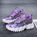 Angled pair view of the Nova Sparkle Luxe Chunky Sneakers in Purple, featuring rich purple layered panels, iridescent and metallic accents, lace-up closures, rounded toes, and bold sculpted white chunky soles for glamorous statement looks.
