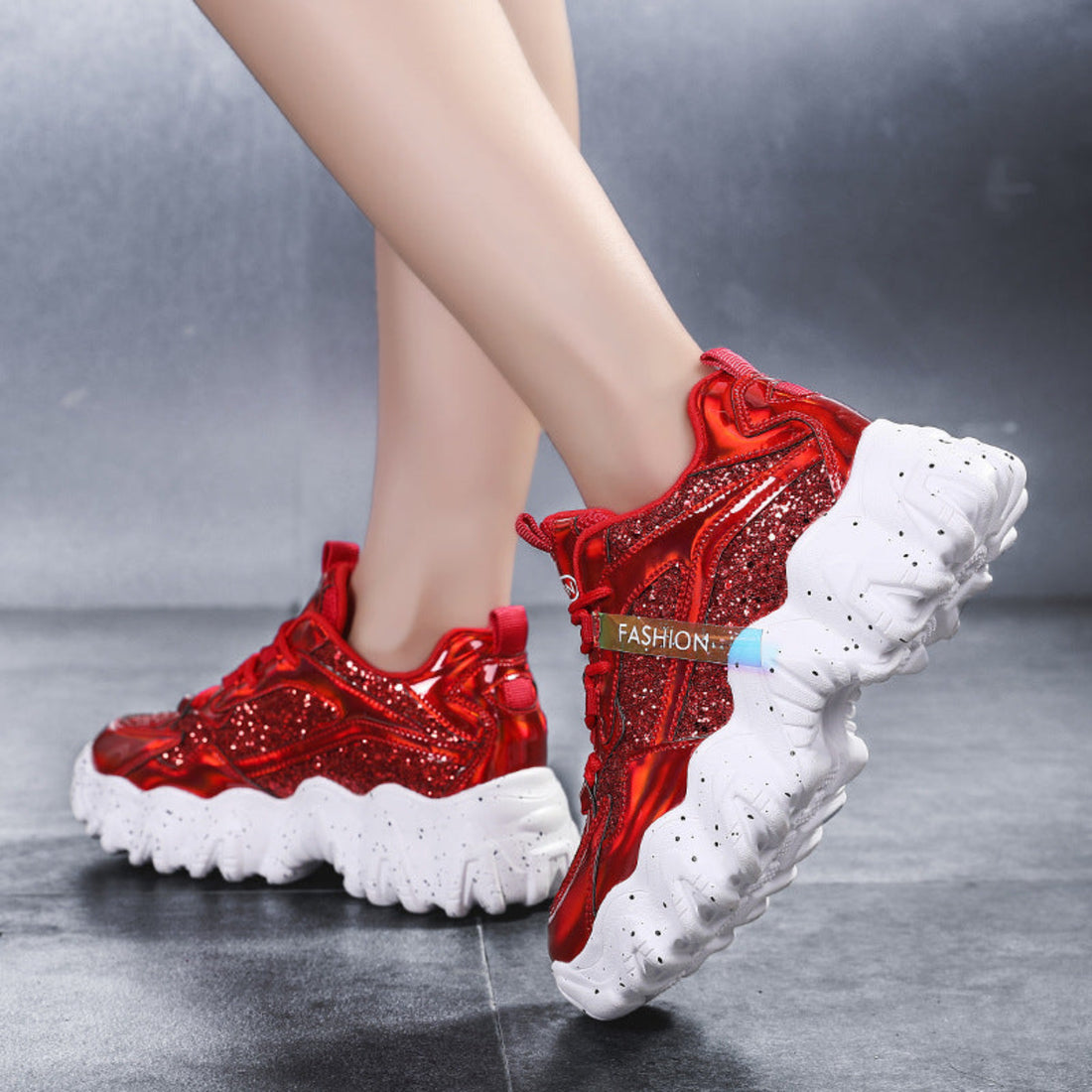 Women's Nova Sparkle Luxe Chunky Sneakers displayed in Purple, Red, and Silver colorways, featuring shimmering layered uppers, metallic and reflective accents, lace-up fronts, rounded athletic toes, and dramatic sculpted white chunky soles designed for bold statement styling.