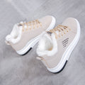 Side pair view of the Sienna Cozy Plush-Lined Platform Sneakers in Beige, showing the light neutral lace-up uppers, soft plush lining around the ankle openings, rounded toe design, low-top silhouette, and thick cushioned white platform soles for cozy everyday Fall and Winter wear. 
