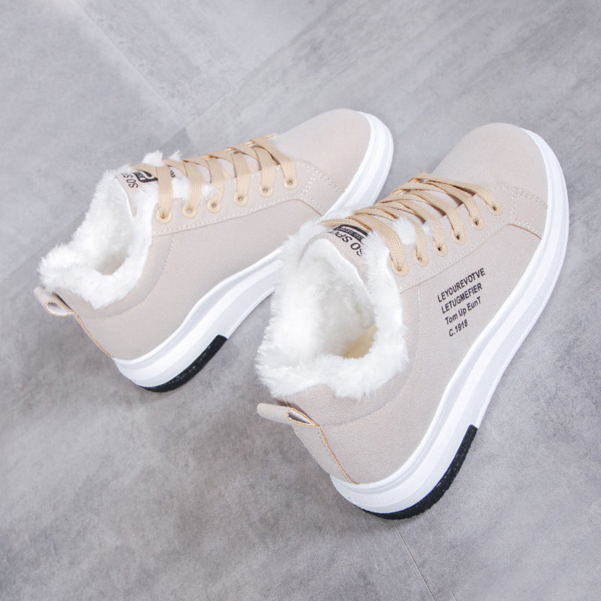 Side pair view of the Sienna Cozy Plush-Lined Platform Sneakers in Beige, showing the light neutral lace-up uppers, soft plush lining around the ankle openings, rounded toe design, low-top silhouette, and thick cushioned white platform soles for cozy everyday Fall and Winter wear. 