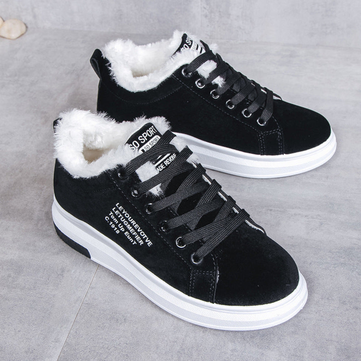 Angled pair view of the Sienna Cozy Plush-Lined Platform Sneakers in Black, featuring sleek black lace-up uppers, contrasting soft white plush lining, rounded toes, low-top construction, and thick white platform soles for stylish and comfortable Fall and Winter outfits.