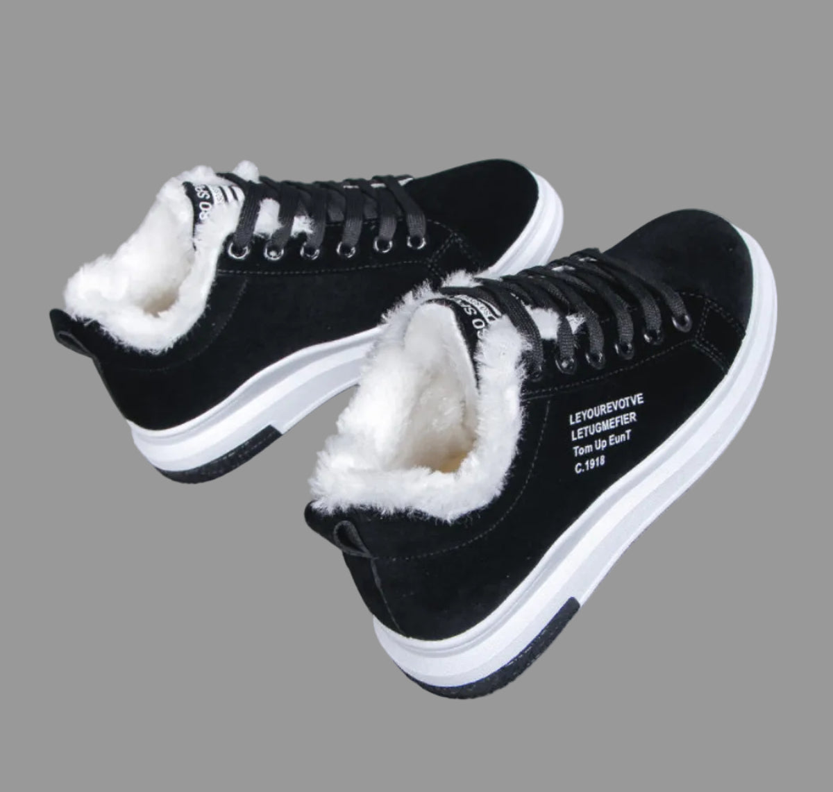 Side view of a pair of Sienna Cozy Plush-Lined Platform Sneakers in Black, showcasing the smooth black uppers, black lace-up closures, warm contrasting white faux-fur style lining, rounded toe shape, and elevated white platform soles for casual cold-weather styling.