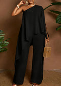 Amara women's elegant black two-piece pants set shown from the front, featuring an asymmetrical one-shoulder top with a flowing cape-style overlay, draped fabric across the torso, and coordinating solid black wide-leg trousers.