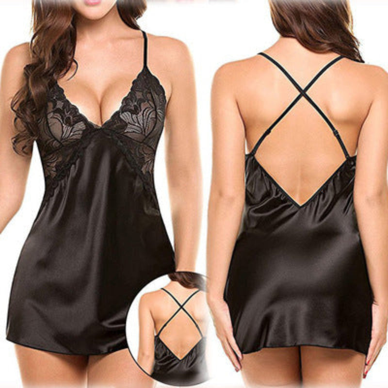 Amara women's classic black satin-look chemise nightdress shown from the front and back on a brunette model, featuring intricate black floral lace cups with scalloped edges, a plunging V-neckline, slender spaghetti shoulder straps, smooth glossy black fabric, and a short flowing hemline. The rear view highlights the low open-back design with thin crisscross straps, while a circular inset provides a closer look at the back strap detailing.