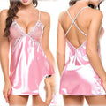 Front and back views of the Amara women's blush pink satin-look lace chemise nightdress, featuring pale pink floral lace cups, a deep V-shaped neckline, delicate spaghetti shoulder straps, and a small satin bow at the center bust. The glossy pink fabric drapes into a short, flowing skirt, while the rear view highlights the open upper back with thin crisscross straps and a softly curved hemline.