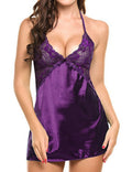 Front view of the Amara women's plum purple satin-look lace chemise nightdress worn by a brunette model, featuring a plunging V-neckline with intricate purple floral lace panels, slender shoulder straps, a small decorative bow beneath the bust, and a rich, glossy plum purple fabric that follows the body before falling into a short, softly curved hemline.