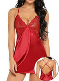 Amara women's ruby red satin-look chemise nightdress displayed on a brunette model, featuring delicate floral lace around the plunging V-neckline, thin adjustable-looking shoulder straps, a small coordinating red bow below the bust, and smooth, glossy red fabric with a gently flowing short hemline. A circular inset shows the back strap construction and satin-look fabric detailing.