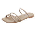 Apricot light taupe women’s minimalist flat sandals featuring slim multi-strap detailing across the front, an additional curved upper strap, open square-toe silhouette, low flat heel, and neutral-toned footbed, shown from an angled side product view on a white background.