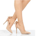 Beige Arielle Bow Ankle-Strap Stiletto Pumps shown on a model, featuring a soft neutral beige finish, dramatic wraparound bow ankle detail, pointed toe, and slender high heel.