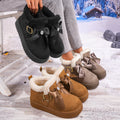 Women’s Aspen Luxe fleece-lined platform snow boots displayed in Black, Camel, and Gray, featuring plush white interior lining, oversized decorative bows, buckle accents, and thick chunky platform soles for cozy winter styling.