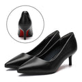 Pair of Audrey black pointed-toe kitten heel work pumps shown from a three-quarter side angle with a close-up inset highlighting the curved back of the heel and distinctive red sole accent.