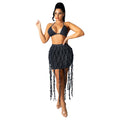 Full view of women's black denim mini skirt with woven design and cascading fringe.