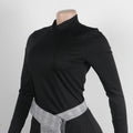 Side view of women's black and plaid asymmetrical two-piece skirt set.