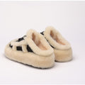 Black and white women's plush thick-sole slippers shown from the back