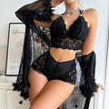 Front view of the Brielle black three-piece lingerie set featuring a black floral lace bra-style top with cutout-inspired details, high-waisted coordinating black bottoms, and a matching sheer black cover-up worn open at the front.