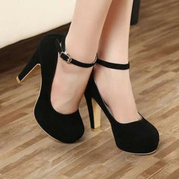 Black Brielle Platform Mary Jane Chunky Heel Pumps worn on a model, featuring a rounded closed toe, thick platform front, high chunky heel, adjustable ankle strap, and soft black finish.