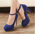 Blue Brielle Platform Mary Jane Chunky Heel Pumps worn on a model, featuring a deep blue finish, rounded closed toe, thick platform sole, chunky high heel, and secure ankle strap.