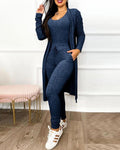 Brielle women's navy blue jumpsuit and cardigan matching set displayed on a model, featuring a fitted sleeveless inner jumpsuit, coordinating long-sleeve open-front cardigan extending toward the knees, and slim tapered pants.
