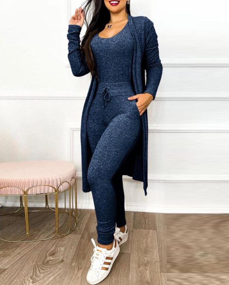 Brielle women's navy blue jumpsuit and cardigan matching set displayed on a model, featuring a fitted sleeveless inner jumpsuit, coordinating long-sleeve open-front cardigan extending toward the knees, and slim tapered pants.