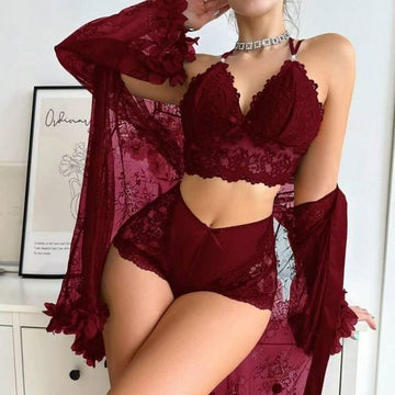 Front view of the Brielle women's wine red three-piece lingerie set shown on a female model, featuring a richly colored lace-detailed bra-style top, matching high-waisted wine red bottoms with decorative lace accents, and a coordinating semi-sheer long-sleeve cover-up draped over the shoulders.