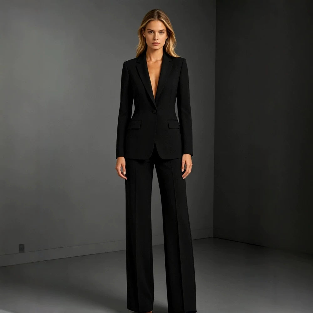 Camille women's black tailored pants suit displayed on a model, featuring a long-sleeve blazer with a classic notched collar and coordinating black wide-leg dress trousers for a sophisticated professional outfit.