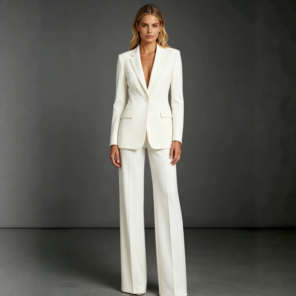 Camille women's black tailored pants suit displayed on a model, featuring a long-sleeve blazer with a classic notched collar and coordinating black wide-leg dress trousers for a sophisticated professional outfit.