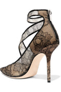 Black Celeste Lace Pointed-Toe Stiletto Pump displayed from a three-quarter angle, featuring an intricate lace-pattern upper, closed pointed toe, slim ankle strap, and tall feminine stiletto heel.