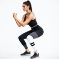 Black Contour Color block women’s workout set with sleeveless top and high-waist leggings shown in squat pose
