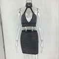 Full-length view of women's sparkling halter top and fitted mini skirt set.