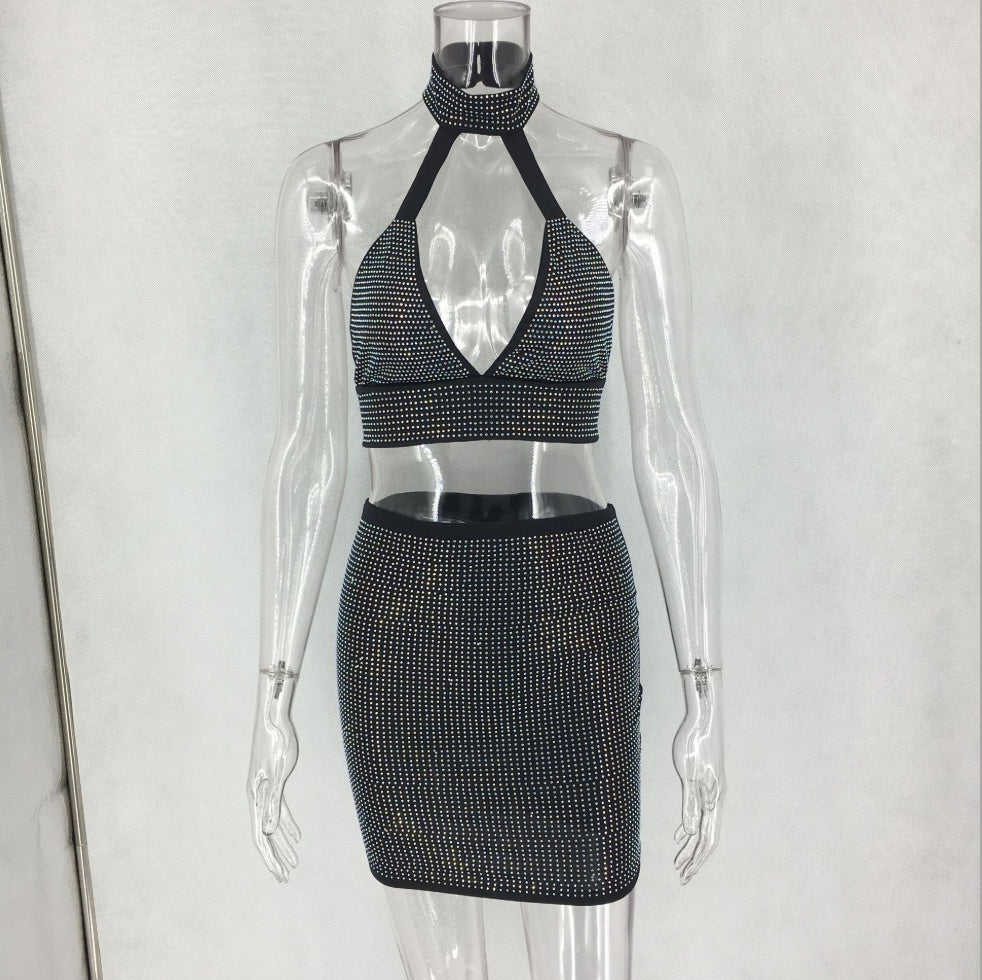 Full-length view of women's sparkling halter top and fitted mini skirt set.