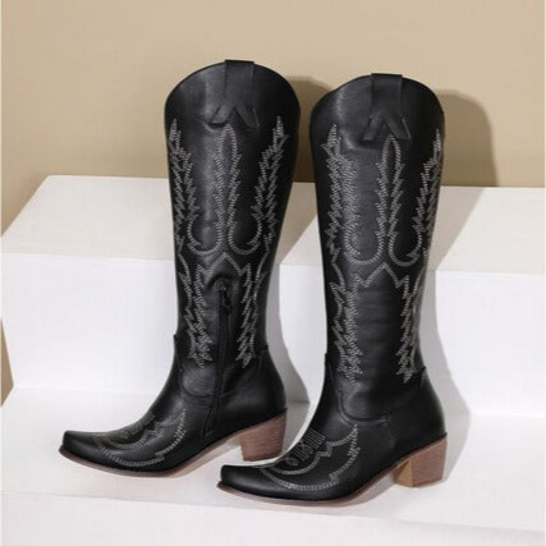 Women’s blue Dakota embroidered Western knee-high boots featuring intricate tonal Western stitching, pointed toes, tall structured shafts, and comfortable low block heels displayed together against a neutral background.