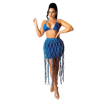 Woman wearing high-waist dark blue denim woven mini skirt with long fringe detailing.