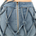 Back view of women's high-waist denim woven fringe mini skirt.