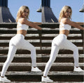 White Everyday Sculpt women’s high-waist leggings with striped side detail shown in a full-body pose on stairs