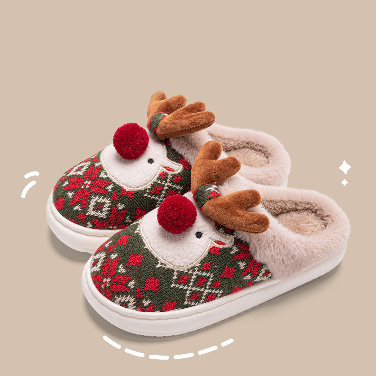 Festive women’s 3D reindeer Christmas slippers shown from an angled product view, featuring a red and green seasonal pattern, raised plush reindeer heads with brown antlers, bright red pom-pom noses, soft beige trim, and cushioned open-back house slipper design.