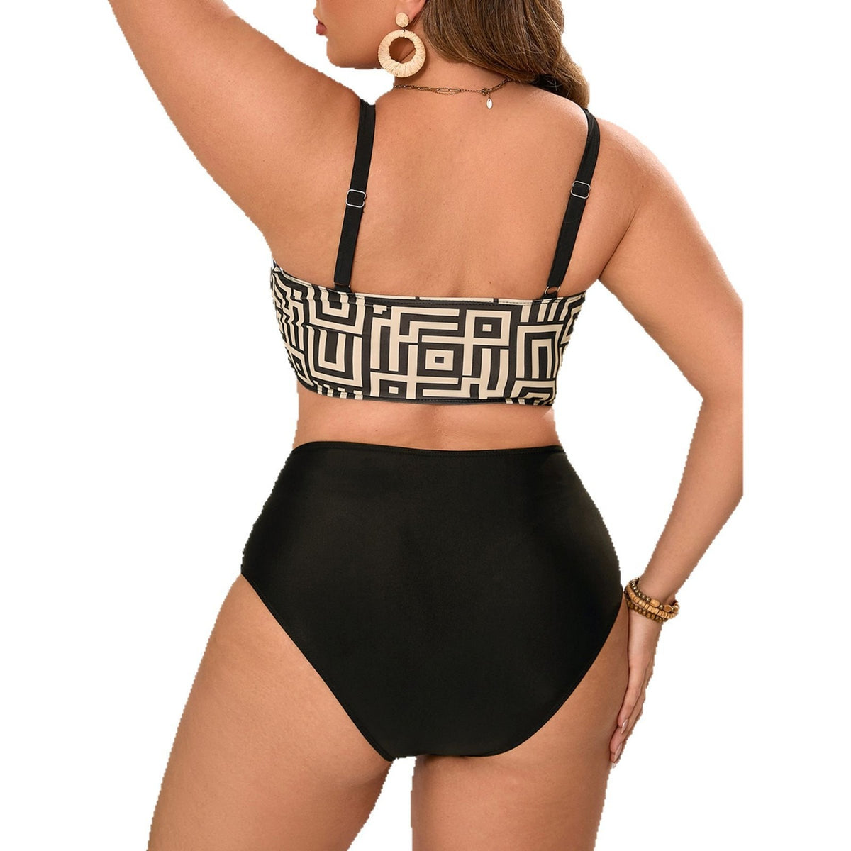 Back view of a woman modeling a black and beige geometric-print two-piece bikini featuring a cropped swim top with adjustable black shoulder straps, a straight-cut back with a bold maze-inspired pattern, and solid black high-waisted bikini bottoms offering full rear coverage and a flattering, smooth silhouette.