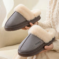 Women is holding gray faux suede plush-lined house slippers