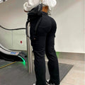 Women's black high-waist stretch cargo pants with utility pockets, back view