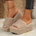 Khaki fleece-lined platform house slippers worn by a woman