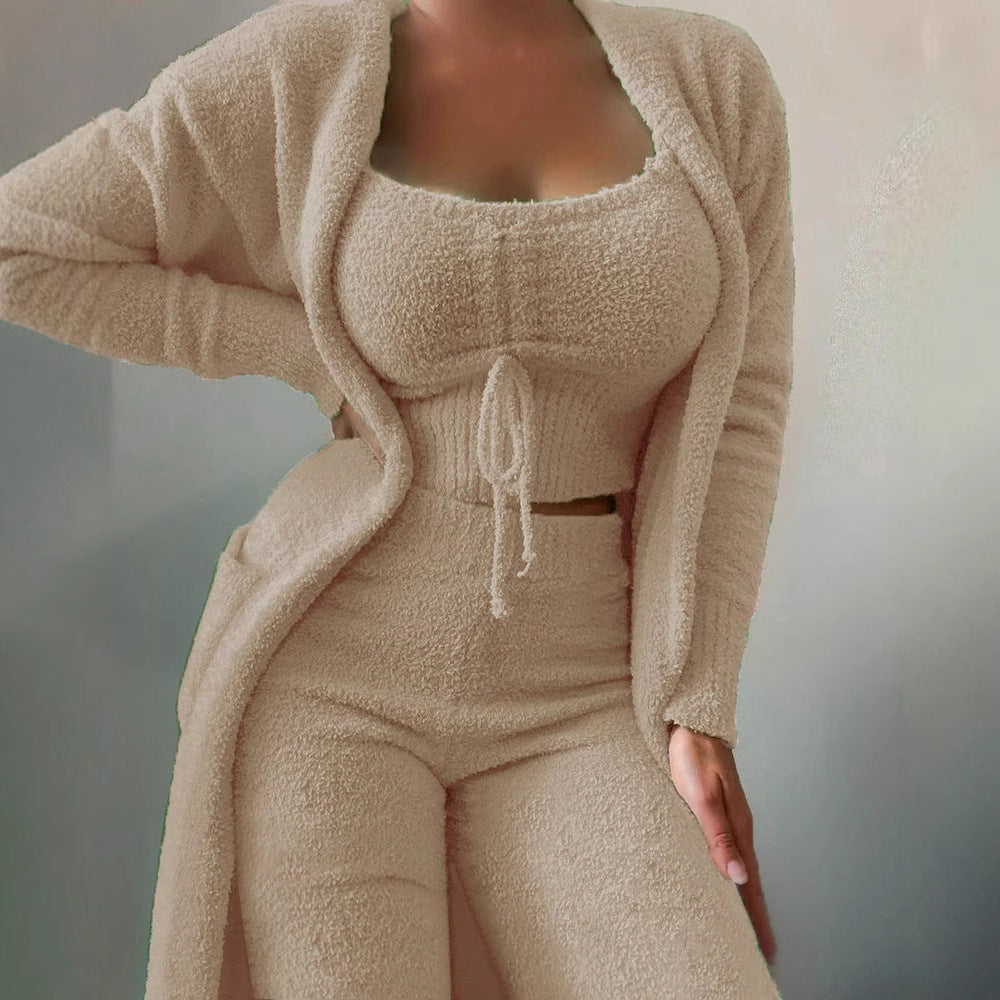 Naomi women's red three-piece matching pants set shown in a front close-up, featuring a fitted square-neck crop top with a center drawstring tie, coordinating long-sleeve open-front cardigan with curved trim detailing, and matching high-waisted pants in textured ribbed fabric.