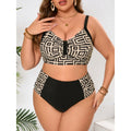Front view of a curvy model wearing a black-and-cream geometric printed bikini top with wide black straps and matching high-waisted bottoms featuring solid black front and patterned side panels.