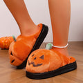 Orange women’s plush pumpkin Halloween slippers shown worn from an angled side view, featuring fuzzy pumpkin-shaped uppers with black jack-o’-lantern facial details, green stem accents, open-back construction, and thick black platform-style soles for cozy seasonal indoor wear.