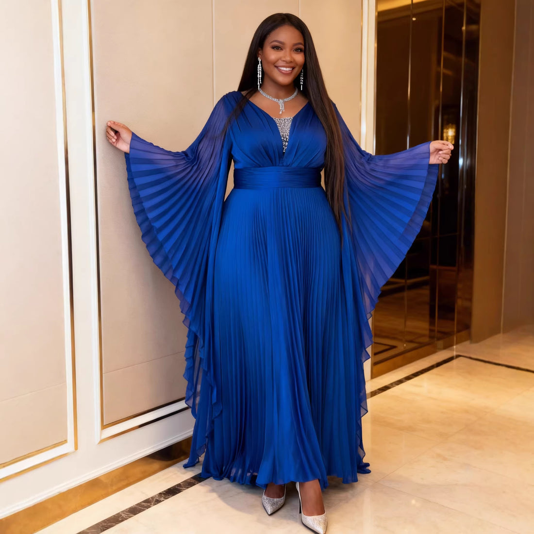 Royal blue pleated maxi gown with flowing cape sleeves and a flattering defined waist.