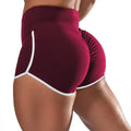 Burgundy SculptCurve plus size high-waist running and workout shorts with contrast trim shown from the back