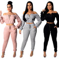 Three women wearing matching Pink, Grey, and Black off-shoulder lace-up cropped tops with coordinating jogger pants against a white background.