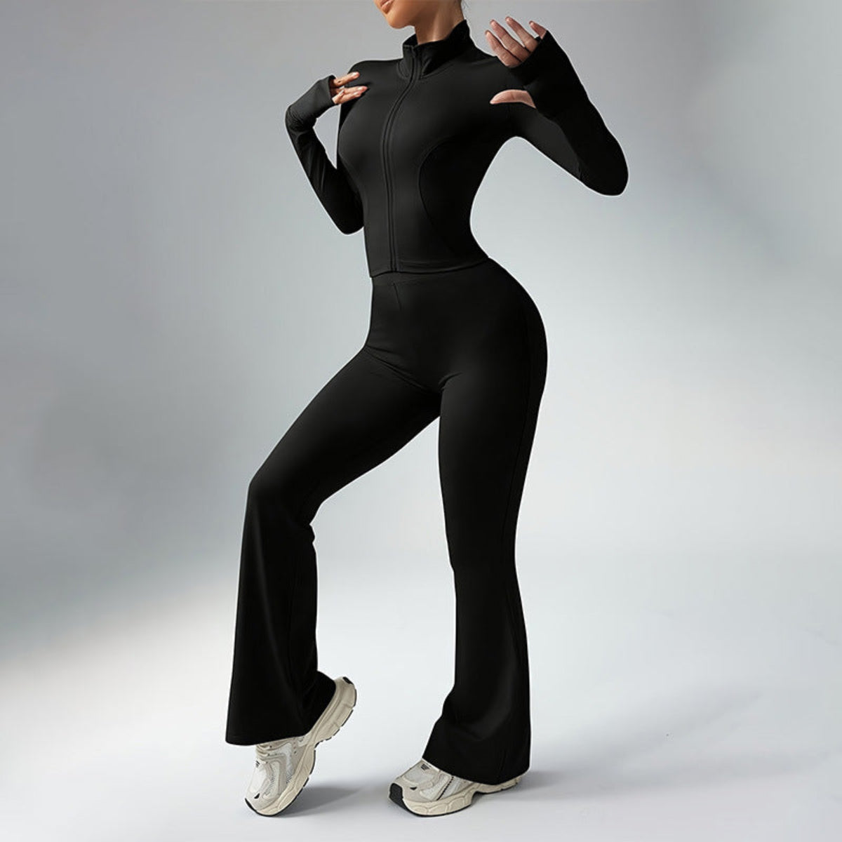 Black Sculpted Silhouette women’s long-sleeve fitness jumpsuit with flared legs shown in side view