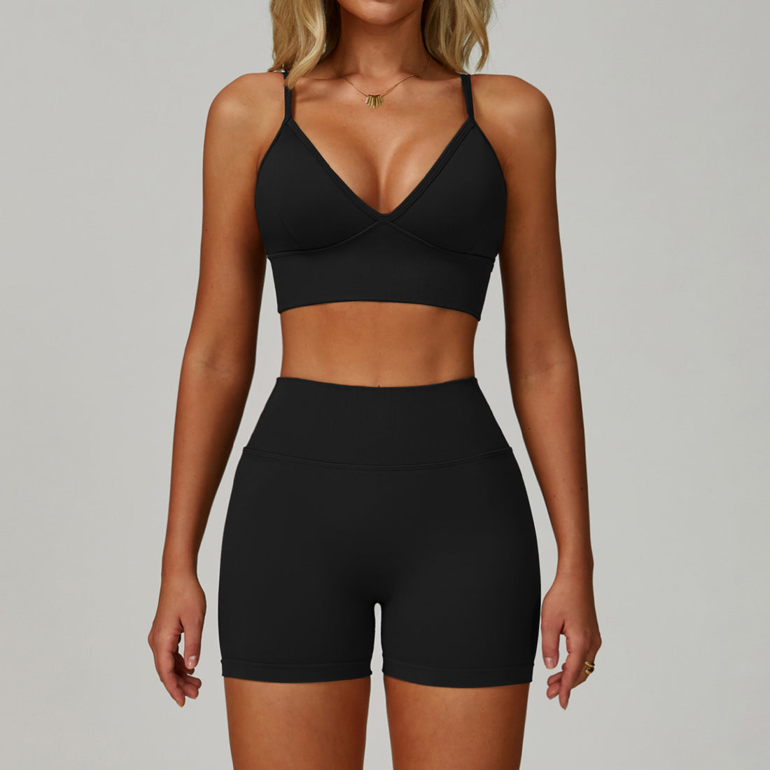 Advanced black SculptFit women’s sports bra and high-waist workout shorts set shown from the front