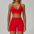 Bright red SculptFit women’s sports bra and high-waist workout shorts set shown from the front