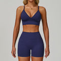 Navy blue SculptFit women’s sports bra and high-waist workout shorts set shown from the front